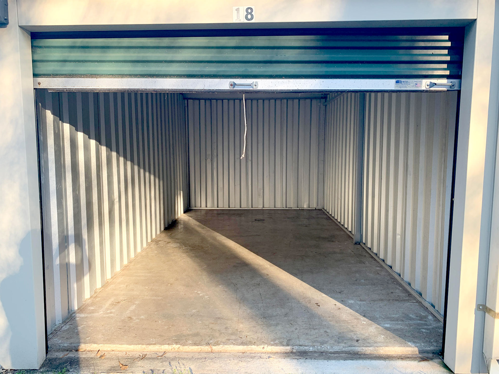 Open storage unit with roll-up door